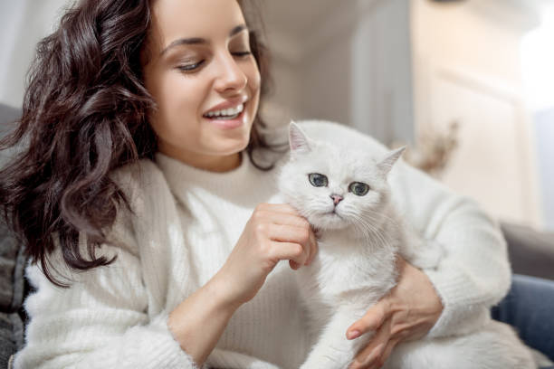 istock Dark-haired young woman with a nice white cat 1313461485