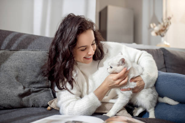 istock Dark-haired young woman with a nice white cat 1313461489