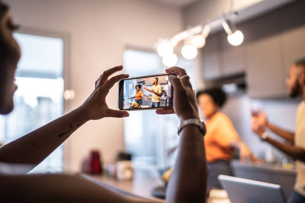 istock Friends dancing and filming it on mobile phone at home 1313461981