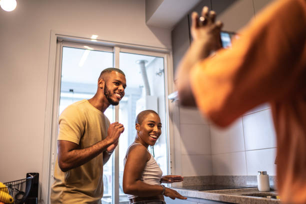 istock Friends dancing and filming it on mobile phone at home 1313462152