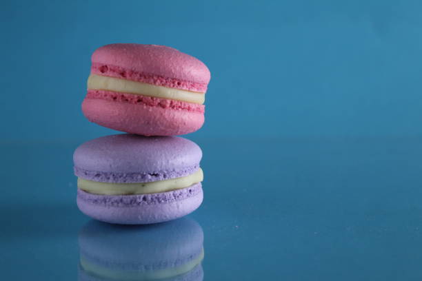 istock three macaroons lie triangle on a blue background with a place for text and copyspace 1313462290