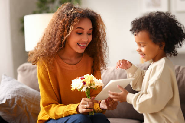 istock Young mixed race woman getting congratulations from son on Mothers day 1313462474