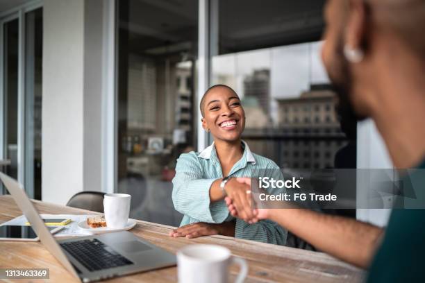 Financial Advisor Shaking Hands With Customer Stock Photo - Download Image Now - Customer, Selling, Service