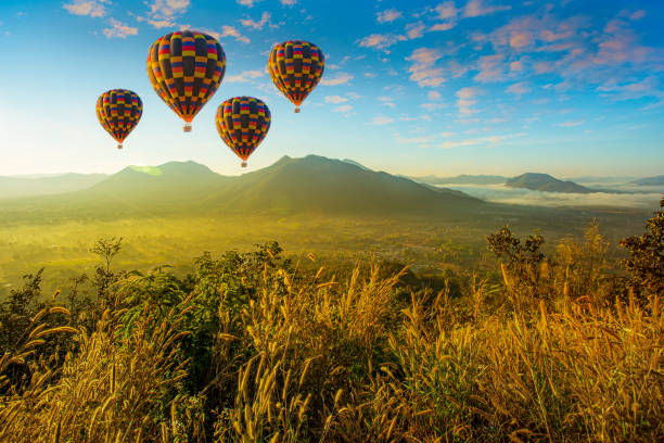 istock Mountain scenery with hot air balloons and beautiful sky 1313464482