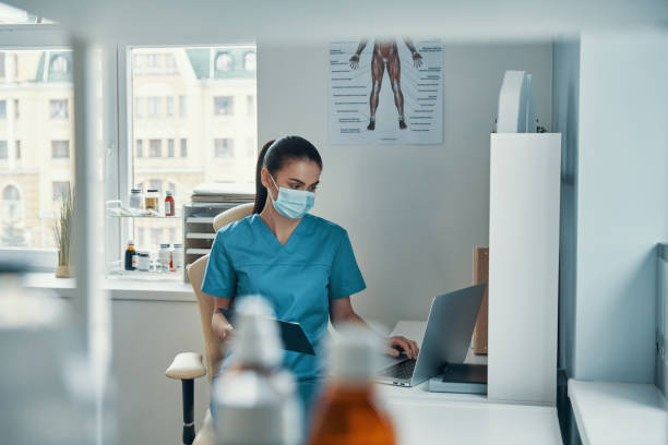 istock Beautiful young female nurse in protective mask 1313465122