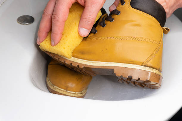 istock a yellow shoe is in a white sink washed with a yellow sponge 1313465713