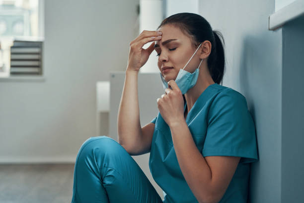 istock Stressed young female nurse in protective face mask 1313465715