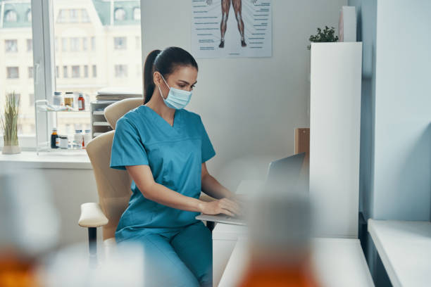 istock Beautiful young female nurse in protective mask 1313465934