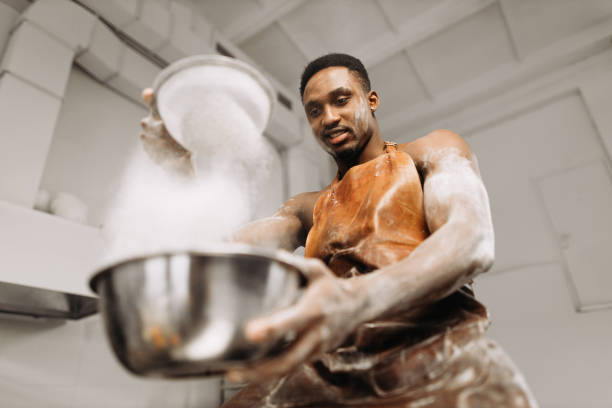istock A young man is sieving flour in a commercial kitchen 1313465952