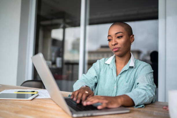 istock Young woman using laptop working at home 1313465968