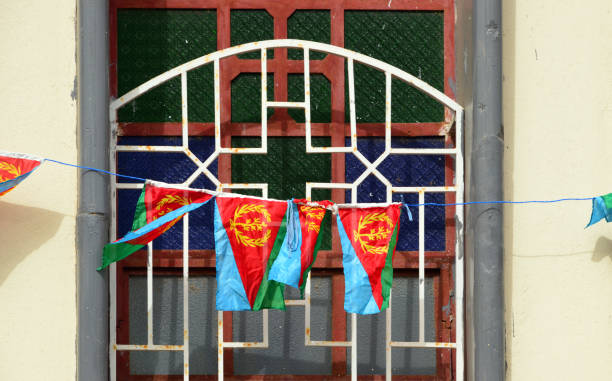 Enda Mariam Coptic Cathedral - crosses and flags, Massawa, Eritrea Taulud Island, Massawa, Northern Red Sea Region, Eritrea: window with crosses and Eritrean flags - St Mary / Enda Mariam Coptic Cathedral, Eritrean Orthodox Tewahedo Church eritrea stock pictures, royalty-free photos & images