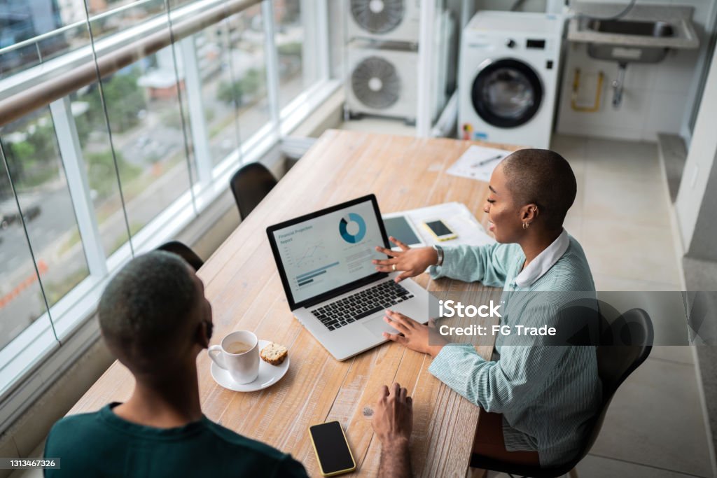 Financial advisor or real estate agent talking to customer at home Data Stock Photo