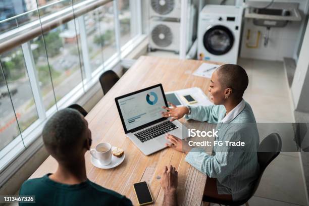 Financial Advisor Or Real Estate Agent Talking To Customer At Home Stock Photo - Download Image Now