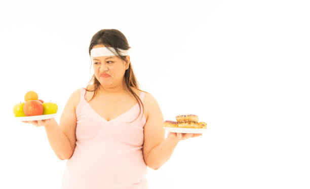 istock An overweight women with various emotions for herself, eating and exercise 1313467893