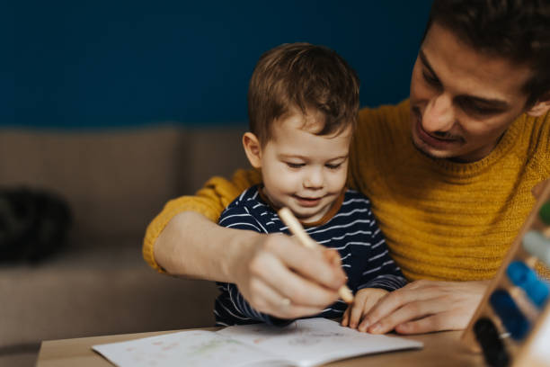 istock Young father teaching little son to draw 1313468629