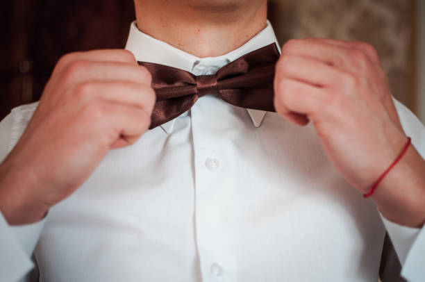 istock Dark red bowtie on the grooms neck 1313468780
