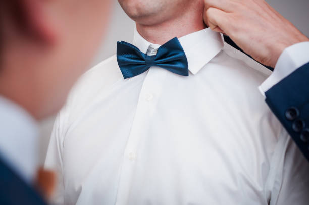 istock Dark blue bowtie on the grooms neck 1313468798