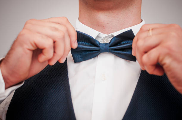 istock Dark blue bowtie on the grooms neck 1313468812