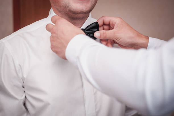 istock Man helps groom to wear tiebow 1313468828