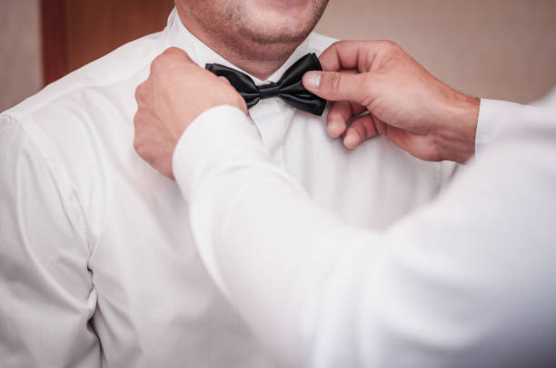 istock Man helps groom to wear tiebow 1313468838