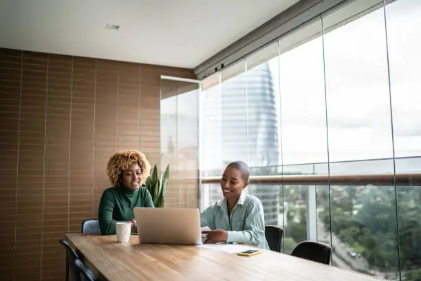 Photo of Financial advisor or real estate agent talking to customer at home