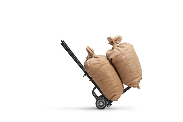 Studio shot of two burlap sacks on a hand truck isolated on white background