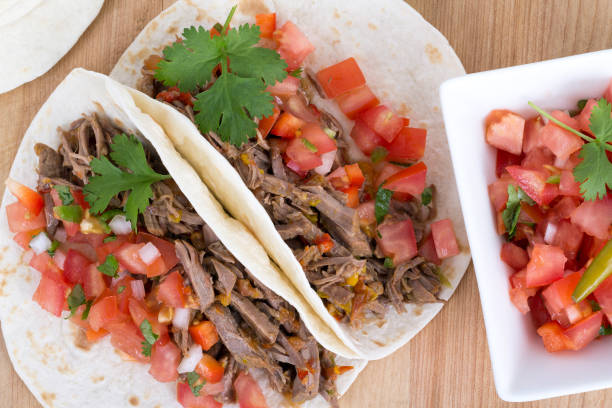 pork or beef cornita taco with pico de gallo closeup
