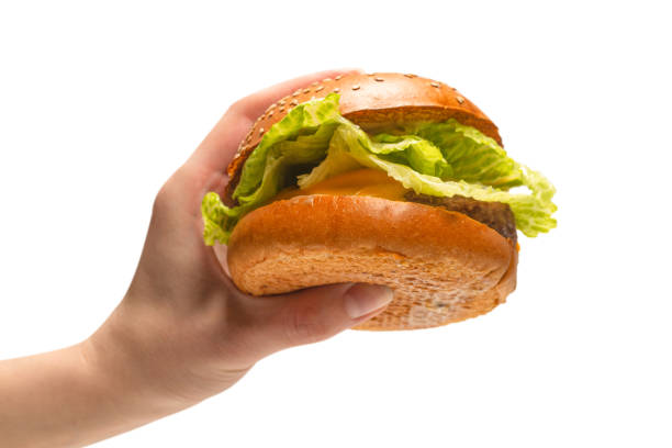 istock Hamburger in woman hands isolated on a white background. 1313472528