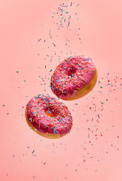 istock donuts with sugar sprinkles on a pink background. 1313473737