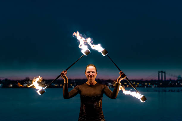 istock Fire artist posing with two flaming torches 1313474336