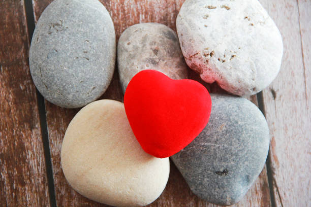 istock red velvet heart on gray stones 1313475113