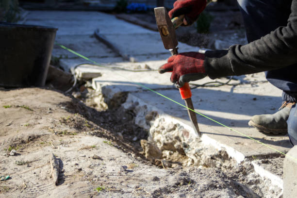 istock Defocus bricklayer removing irregularities on floor screed with hammer and chisel. Male hands in red work gloves hold a hammer and chisel. Out of focus 1313475273