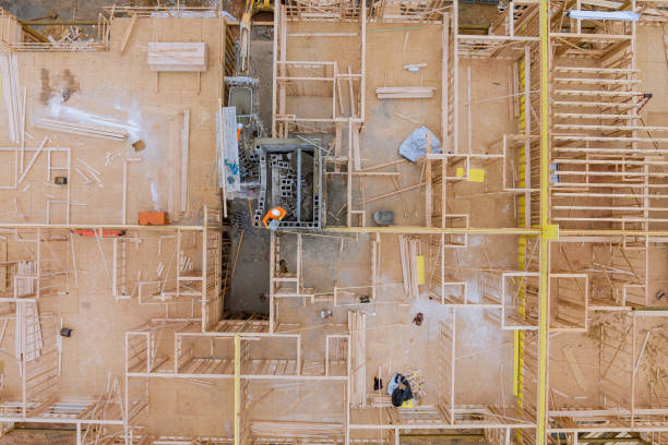 istock Aerial view of elevator shaft for concrete block building under construction on workers are laying blocks 1313475986