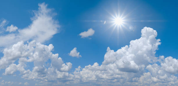 istock Beautiful clear blue sky with white clouds and sun 1313479172