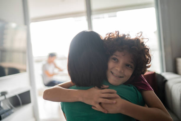 istock Boy embracing mother at home 1313480655