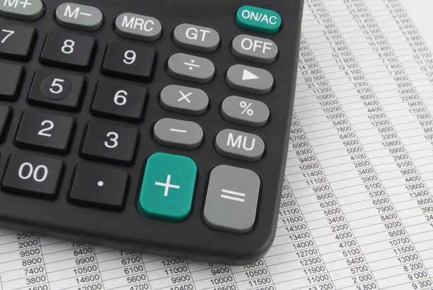 istock Calculator on report with financial data, many numbers in rows. 1313482117
