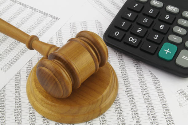 istock Judge gavel and calculator on financial reports. 1313482287