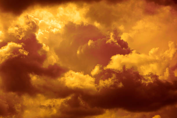 Photo of Golden sunset. Dramatic orange yellow sky. Thunderclouds. Colorful sky background with copy space for design.