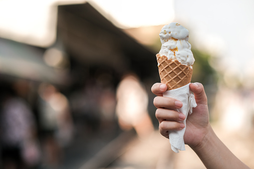 Girl holding a vanilla ice cream cone