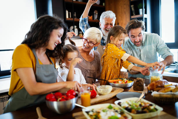 istock Cheerful family spending good time together while cooking in kitchen 1313484948