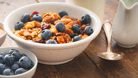 White bowl with large black flame raisins from Chile close up