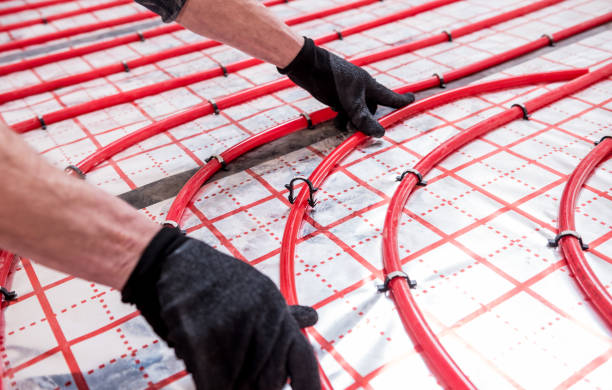 istock Pipefitter install system of underfloor heating system at home 1313486308