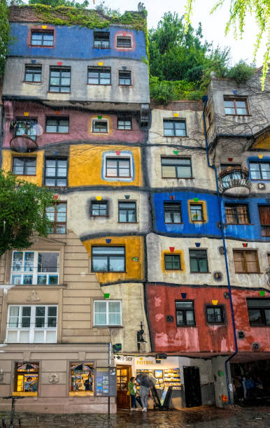 Beautiful colorful facade of the Hundertwasser House in Vienna, Austria. Modern architecture of the Austrian capital Vienna, Austria - July 13 2019: colorful bright house, designed by renowned Austrian architect Friedensreich Hundertwasser. The streets of ancient Vienna, the tourist attraction of Austria hundertwasser house stock pictures, royalty-free photos & images