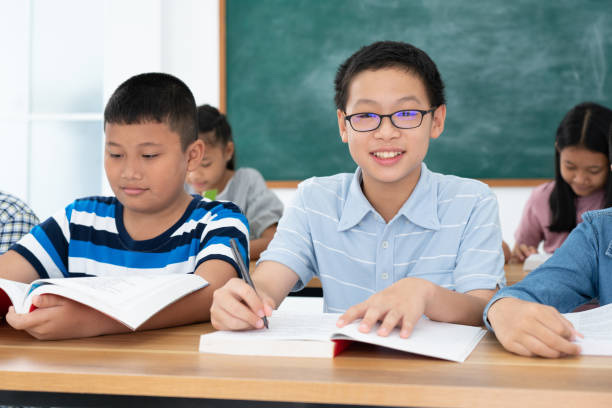 istock Group Asian students smile and enjoy doing activities with their classmates. Concept of education 1313487895