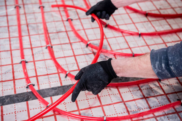 istock Pipefitter install system of underfloor heating system at home 1313488987