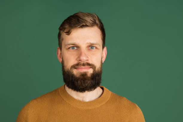 istock Caucasian man's portrait isolated over green studio background with copyspace 1313489066