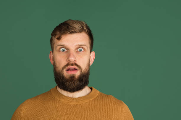 istock Caucasian man's portrait isolated over green studio background with copyspace 1313489068