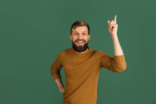 istock Caucasian man's portrait isolated over green studio background with copyspace 1313489079