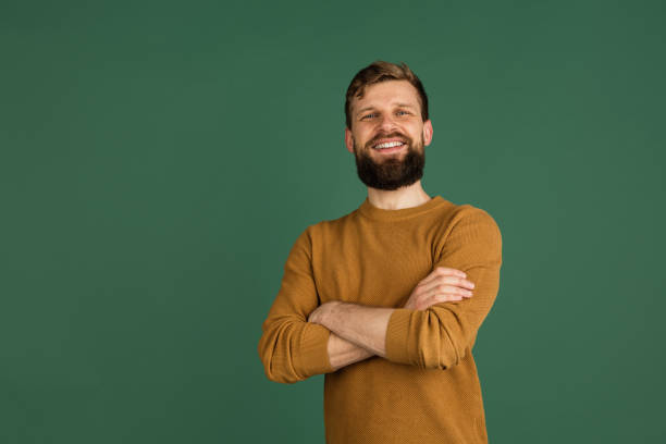 istock Caucasian man's portrait isolated over green studio background with copyspace 1313489092