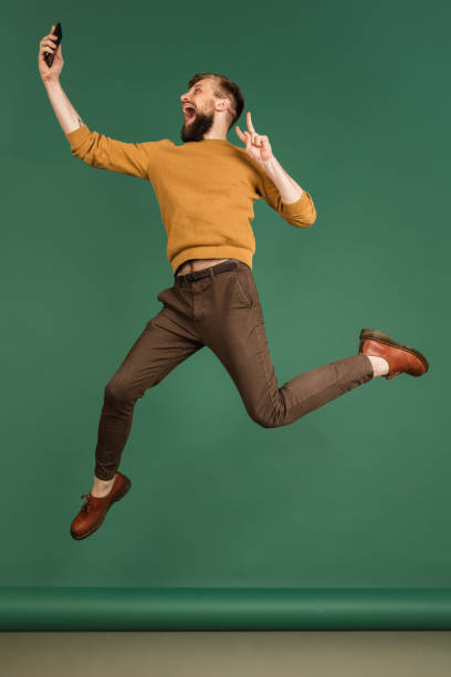 istock Caucasian man's portrait isolated over green studio background with copyspace 1313489112